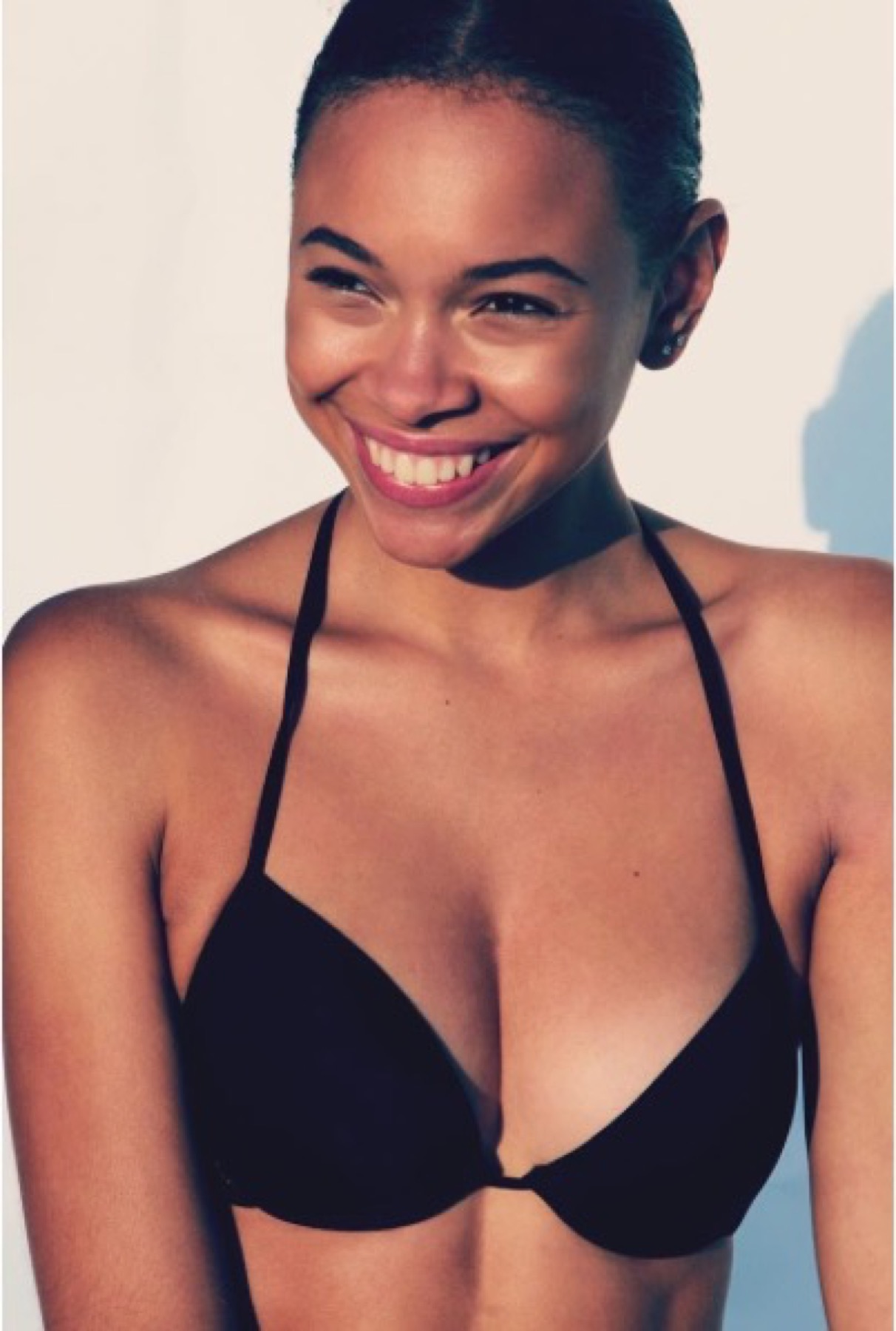FEE smiling in a black halter beauty portrait