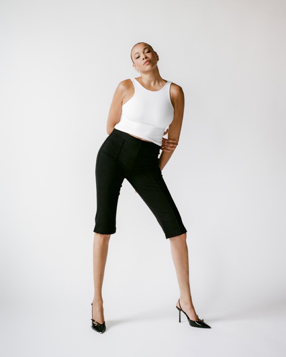 FEE standing studio portrait in white crop top